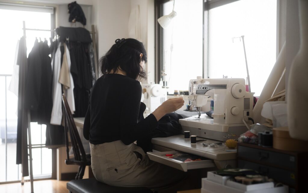 medium shot woman sewing